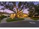 Beautiful home with circular tower, stone driveway, and manicured landscaping at twilight at 2279 Mermaid Ne Pt, St Petersburg, FL 33703
