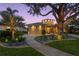 Elegant home with circle architectural detail, lush landscaping, and paved driveway at twilight at 2279 Mermaid Ne Pt, St Petersburg, FL 33703