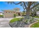 Stunning home with manicured lawn, stone landscaping, and circular architectural detail at 2279 Mermaid Ne Pt, St Petersburg, FL 33703