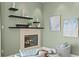Stylish fireplace with mantle sits between two chairs in the main bedroom suite at 2279 Mermaid Ne Pt, St Petersburg, FL 33703