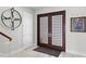 Elegant foyer with a striking dark wood double door, tile flooring, and modern decor at 2279 Mermaid Ne Pt, St Petersburg, FL 33703