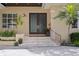 Front entrance of home with double doors, stone steps, and well-maintained landscaping at 2279 Mermaid Ne Pt, St Petersburg, FL 33703
