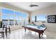 Well-lit game room with water views, showcasing a pool table and comfortable seating area at 2279 Mermaid Ne Pt, St Petersburg, FL 33703