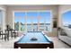 Spacious game room includes a pool table with waterfront views through expansive windows at 2279 Mermaid Ne Pt, St Petersburg, FL 33703