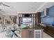 Expansive kitchen with stainless appliances, custom island, mosaic backsplash, and connected living spaces at 2279 Mermaid Ne Pt, St Petersburg, FL 33703