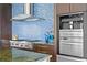 Chef's kitchen features high-end appliances, custom cabinetry, and stylish mosaic tile backsplash at 2279 Mermaid Ne Pt, St Petersburg, FL 33703