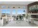 Bright living room features a modern fireplace, water views, and stylish furniture at 2279 Mermaid Ne Pt, St Petersburg, FL 33703