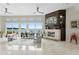 Spacious living room features a modern fireplace, water views, and stylish furniture at 2279 Mermaid Ne Pt, St Petersburg, FL 33703