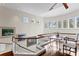 Bright open loft with hardwood floors, a glass railing, multiple windows and a decorative table and chair set at 2279 Mermaid Ne Pt, St Petersburg, FL 33703