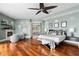 Spacious main bedroom showcasing hardwood floors, a fireplace, sitting area, and view to billiards room at 2279 Mermaid Ne Pt, St Petersburg, FL 33703