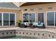 Inviting outdoor seating area by the pool with comfortable furniture and waterfront views at 2279 Mermaid Ne Pt, St Petersburg, FL 33703