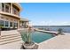 Outdoor oasis showcasing a large pool, patio with outdoor kitchen, and waterfront views at 2279 Mermaid Ne Pt, St Petersburg, FL 33703