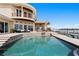 Spacious pool area with outdoor dining and bar, surrounded by lush landscaping and stunning views at 2279 Mermaid Ne Pt, St Petersburg, FL 33703