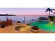 Outdoor pool and spa with bay view, surrounded by beautiful pavers and landscaping at 2279 Mermaid Ne Pt, St Petersburg, FL 33703