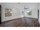 Open-concept living room featuring hardwood floors, large windows, modern ceiling fan, and white walls at 2560 4Th S Ave, St Petersburg, FL 33712