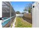 Backyard features a screened in pool with a white fence, and grass at 412 Manor Blvd, Palm Harbor, FL 34683
