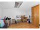 The basement is a large empty space with wood floors and a view of clutter at 412 Manor Blvd, Palm Harbor, FL 34683