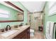 The bathroom features a double sink vanity, a glass-enclosed shower, and modern fixtures at 412 Manor Blvd, Palm Harbor, FL 34683
