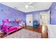 Colorful ' bedroom with hardwood floors, butterfly decals, and a double door closet at 412 Manor Blvd, Palm Harbor, FL 34683