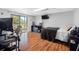 Bedroom boasts a large window with a desk, dark dresser, and mounted TV at 412 Manor Blvd, Palm Harbor, FL 34683