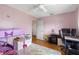 The pink bedroom showcases ' toys, a desk, and wood floors at 412 Manor Blvd, Palm Harbor, FL 34683