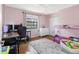 This pink bedroom has a desk and a small bed at 412 Manor Blvd, Palm Harbor, FL 34683