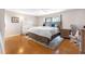 Serene bedroom featuring hardwood floors, modern furniture, and a plush area rug at 412 Manor Blvd, Palm Harbor, FL 34683