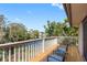 Relaxing deck featuring views of the serene lake and mature trees in a quiet neighborhood at 412 Manor Blvd, Palm Harbor, FL 34683