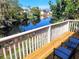 Scenic view from the wooden deck, overlooking the tranquil lake and lush greenery at 412 Manor Blvd, Palm Harbor, FL 34683