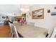 Open dining area with hardwood floors and an adjacent living area with a stone fireplace at 412 Manor Blvd, Palm Harbor, FL 34683