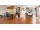 Open-concept dining area with wood floors, connecting to the kitchen and dining room at 412 Manor Blvd, Palm Harbor, FL 34683
