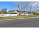 Side view of home, showcasing spacious yard and a partial view of the backyard and the house at 412 Manor Blvd, Palm Harbor, FL 34683