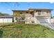 Inviting home with a balcony, white picket fence, and manicured landscaping at 412 Manor Blvd, Palm Harbor, FL 34683