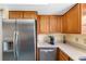 Close-up of kitchen with stainless steel appliances, wood cabinetry, and countertop at 412 Manor Blvd, Palm Harbor, FL 34683