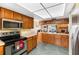 Open-concept kitchen with wood cabinetry, quartz counters, and stainless appliances at 412 Manor Blvd, Palm Harbor, FL 34683