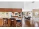Open kitchen with breakfast bar flows into dining area, featuring wood cabinets and stainless appliances at 412 Manor Blvd, Palm Harbor, FL 34683