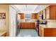 Efficient kitchen design with wood cabinets, stainless steel appliances, and ample counter space at 412 Manor Blvd, Palm Harbor, FL 34683