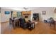 Cozy living room with stone fireplace, hardwood floors, and access to outdoor balcony at 412 Manor Blvd, Palm Harbor, FL 34683