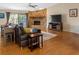 Inviting living room with stone fireplace, hardwood floors, and natural light at 412 Manor Blvd, Palm Harbor, FL 34683