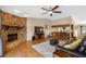 Spacious living room featuring stone fireplace, hardwood floors, and ample seating at 412 Manor Blvd, Palm Harbor, FL 34683
