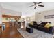 Bright living room featuring hardwood floors, ceiling fan, and open floorplan to the kitchen and dining area at 412 Manor Blvd, Palm Harbor, FL 34683