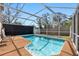 Screened-in pool with ample seating, providing a serene and private outdoor space for relaxation and enjoyment at 412 Manor Blvd, Palm Harbor, FL 34683