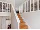 Staircase with light wood steps, white railings, and convenient shoe storage at 412 Manor Blvd, Palm Harbor, FL 34683