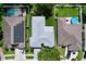 This aerial view shows a home with a gray roof and solar panels. The neighborhood has mature landscaping at 4315 Whittner Dr, Land O Lakes, FL 34639