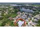 Aerial view of a residential neighborhood with a lake, mature trees, and well-maintained homes at 4315 Whittner Dr, Land O Lakes, FL 34639