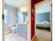 Bathroom has a sink, toilet, drawers, large mirror, and opens to a bedroom at 4315 Whittner Dr, Land O Lakes, FL 34639