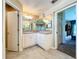 Bathroom with a large vanity, double mirrors, neutral tile flooring, and doorways to other rooms at 4315 Whittner Dr, Land O Lakes, FL 34639