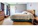 Bedroom boasts soft gray walls, plush carpeting, a wooden bed frame, and a window with blue curtains at 4315 Whittner Dr, Land O Lakes, FL 34639
