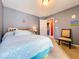 Bedroom features a queen bed, gray walls, light carpet, and decor at 4315 Whittner Dr, Land O Lakes, FL 34639