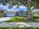 Charming single-story home with a well-manicured lawn, beautiful landscaping, and a two-car garage at 4315 Whittner Dr, Land O Lakes, FL 34639